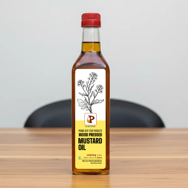 Bottle of wood pressed mustard oil with a red cap on a gray background